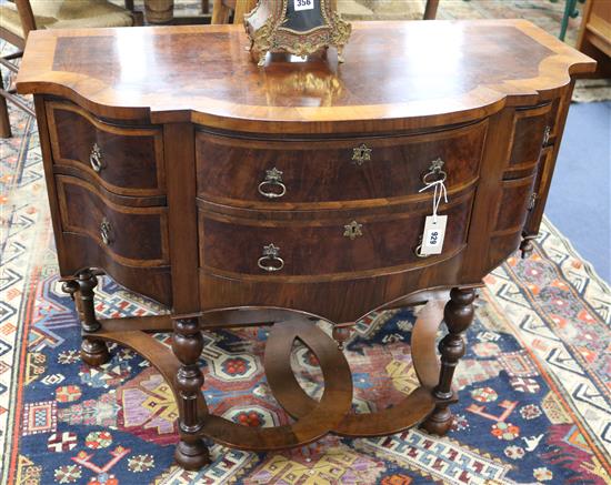 A walnut serpentine chest